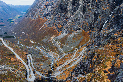 Dramatic high-angle photo of beautiful curvy mountain pass with idyllic view of mountain valley in Western Norway, Scandinavia