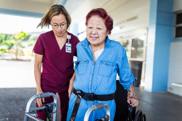 istock Elderly woman using mobility walker with assistance from her home caregiver 1830638885