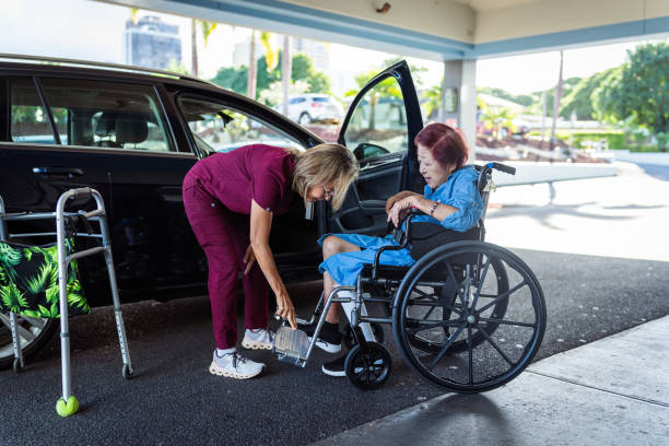istock Home caregiver nurse helps elderly patient into car 1830638892