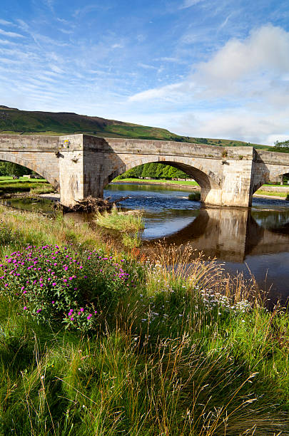Burnsall Bridge In The Yorkshire Dales The bridge at Burnsall in England's Yorkshire Dales. wharfe river photos stock pictures, royalty-free photos & images