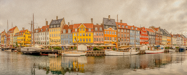 Panorama of Nyhavn with colorful houses and boats moored at the quayside, Copenhagen, November 25, 2023