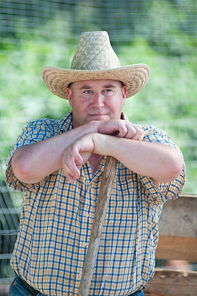 istock Farmer resting on his shovel after work - III 183064633