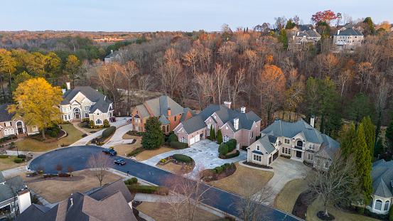 Aerial panoramic view of an upscale subdivision in suburbs of USA shot during golden hour in December 2023