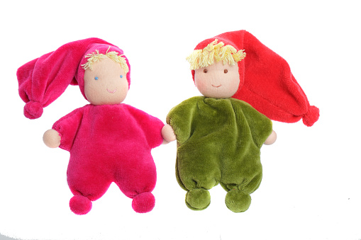 Colorful handmade textile plush doll toy isolated on white background. Red and green color baby toy