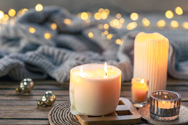istock Cozy background with burning candles and knitted element. 1830651855