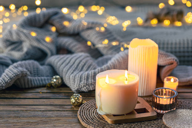 istock Cozy background with burning candles and knitted element. 1830652366