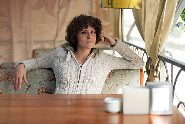 Young woman day dreaming by window
