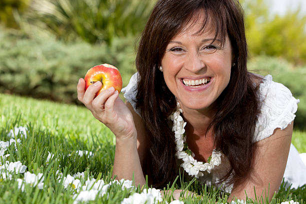 Woman picking some organic apples from family orchard