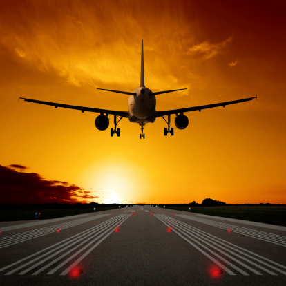 jet airplane landing on runway at sunset, square frame (XL)