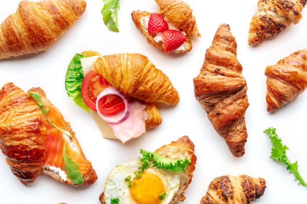 istock Croissant sandwich variety. Various stuffed croissants, overhead flat lay 1830664593