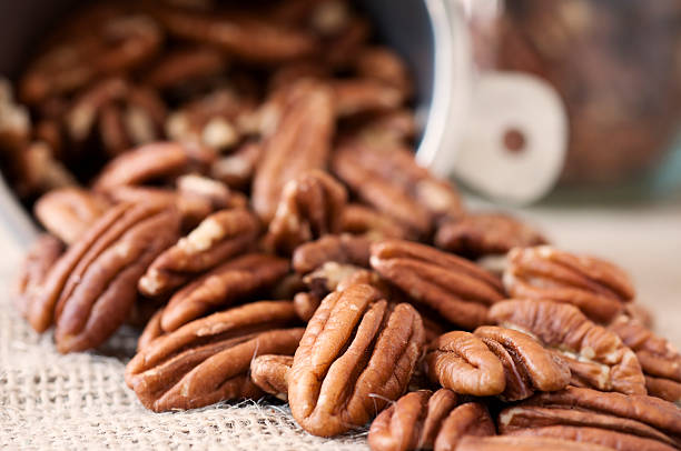 Pecan Halves Tumbling out of a Measuring Cup