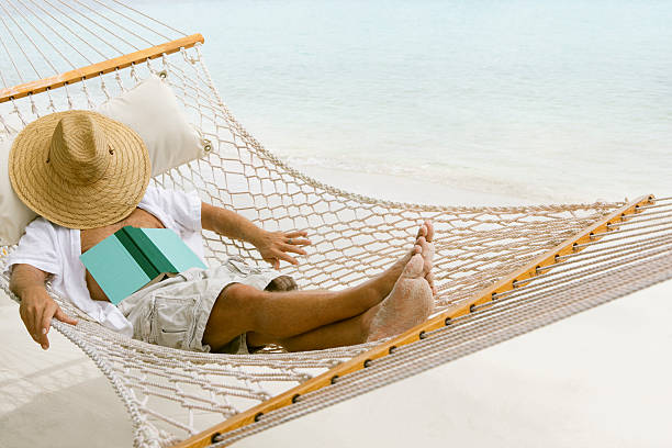 unrecognizable man relaxing in a hammock at the Caribbean beachview images from the same series: