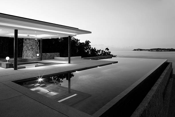 Island Villa In B&W Island Villa With Outdoor Swimming Pool In Black & White. monochrome house stock pictures, royalty-free photos & images