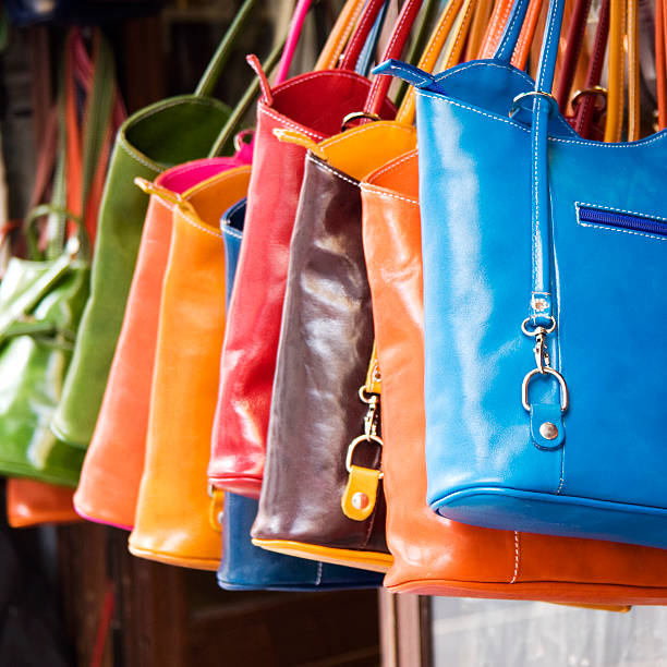 istock Colorful large hand bags hanging from rack 183068088