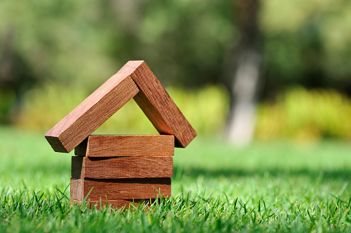 wooden miniature house isolated on the white background for real estate and construction concepts.