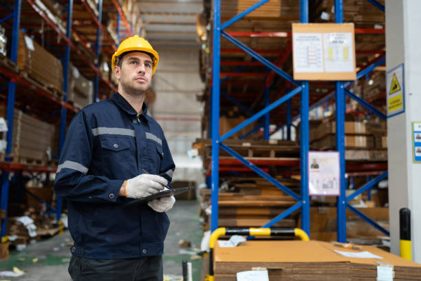 istock Portrait Caucasian businessman workers using tablet computer checking Kraft paper stock in warehouse 1830684596