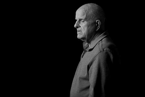 90 year old male contemplating. Black and white studio shot.