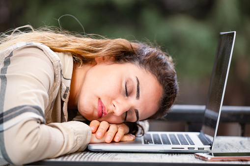 Young Beautiful Woman sleeping on the laptop
