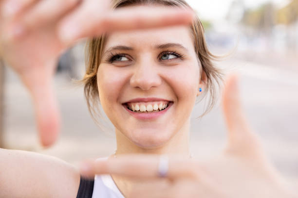 istock Smiling happy young woman gesturing frame with hands 1830696415