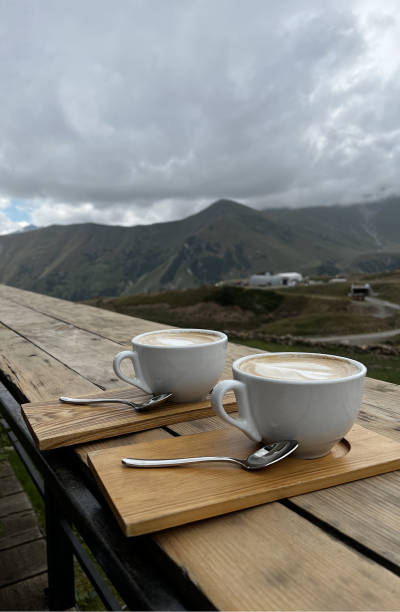 Drinking coffee outdoors.