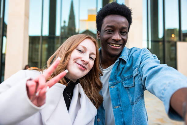 istock Multiracial couple taking a selfie together and smiling at camera 1830697095