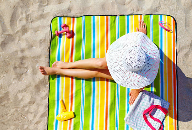 istock seductive woman taking sunbathe on beach 183070170