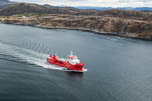 red rescue and firefighting boat in norwegian waters