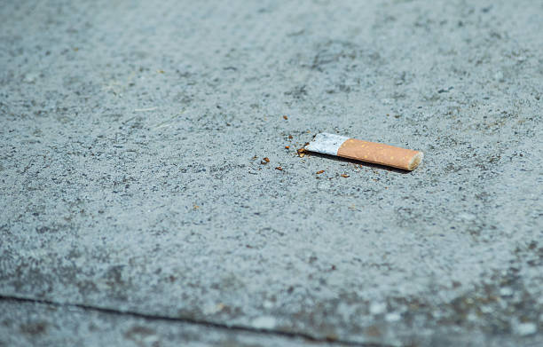 istock Used and Crushed Cigarette Fliter on Pavement 183070702