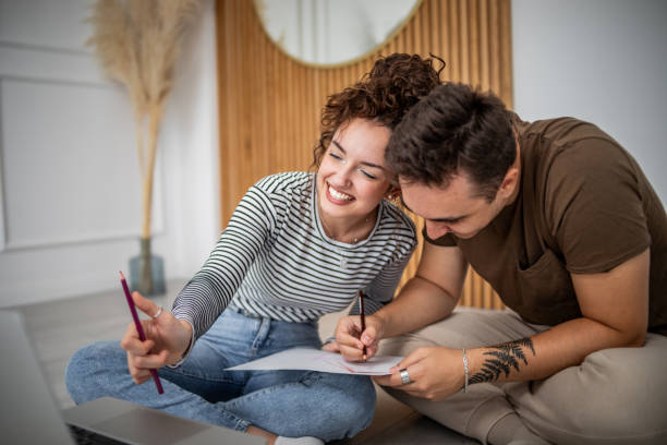 istock Young beautiful couple learning painting online 1830721840