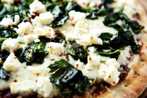 istock Pizza with mozzarella cheese and spinach. Dark wooden background. Close up. 1830735307