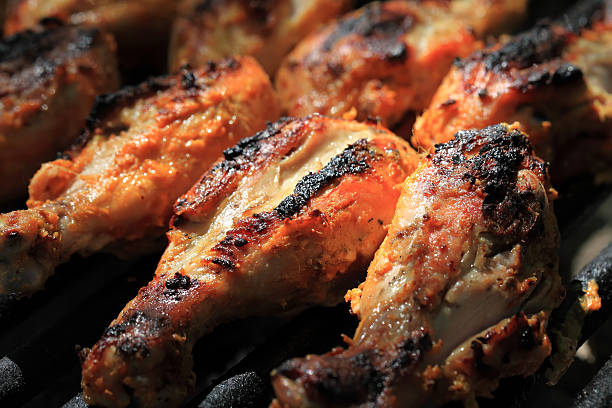 Barbeque chicken with herbs. Chicken on the BBQ grill. drumstick stock pictures, royalty-free photos & images