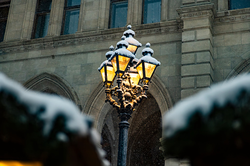 Snow-covered antique street lights in the old town of Vienna in winter