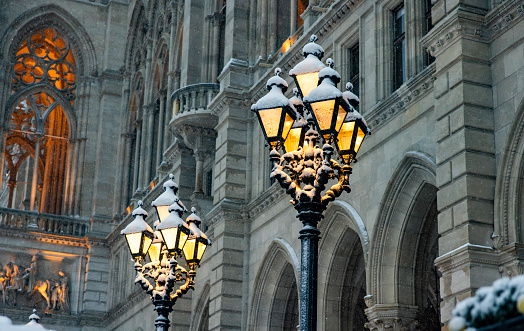 Snow-covered antique street lights in the old town of Vienna in winter