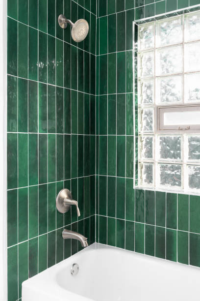 istock A shower with green vertical subway tiles. 1830760600