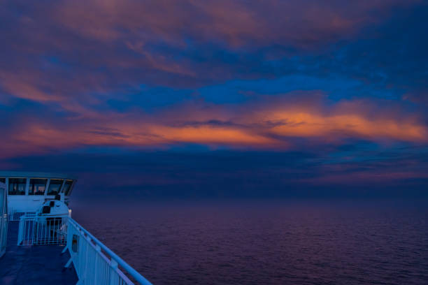 Beautiful Orange Sunset in the Ocean captured from a ferry deck between Denmark, and Faroe Islands