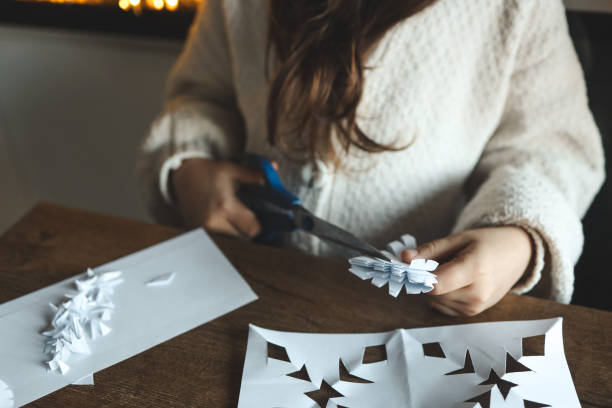 istock Children cut out snowflakes, Christmas activity 1830767578