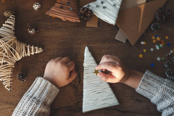 istock Child makes Christmas decoration from yarn 1830768668
