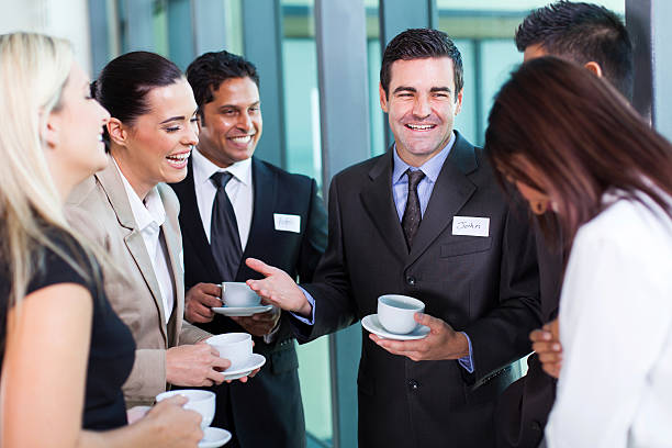 funny businessman telling a joke funny businessman telling a joke during conference coffee break Event Staff/Usher stock pictures, royalty-free photos & images