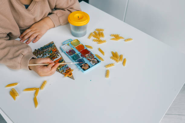 istock Sensory creative activity for children, child coloring pasta 1830777954