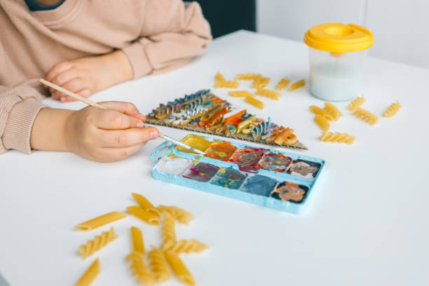 istock Sensory creative activity for children, child coloring pasta 1830778535