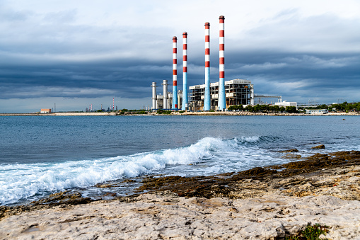 View of the French gas-fired power plant in Martigues and its four old chimneys, which are no longer in operation. Threatening clouds can be seen in the background