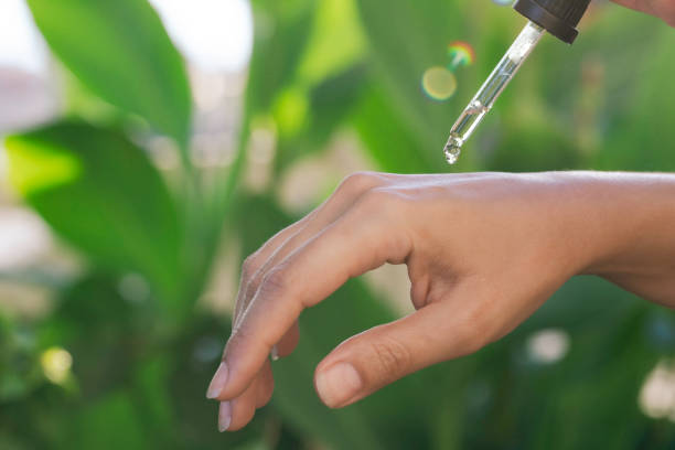istock Woman Applying Serum to Her Hand 1830785022