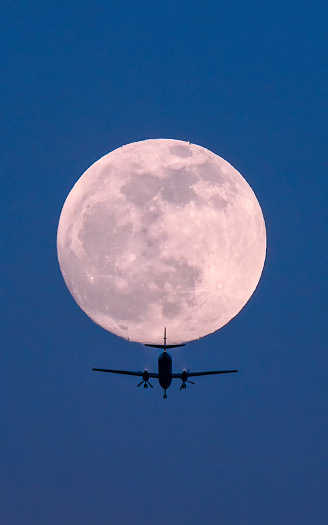 plane flying through the moon