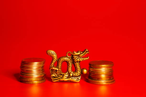 A figurine of a Chinese dragon with coins.