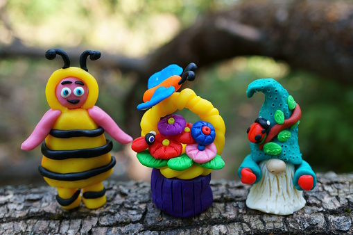 Photo of a toy bee and a plasticine gnome.