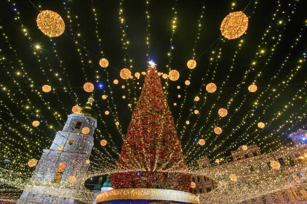 istock Illuminated Christmas tree with garlands against night sky 1830809239