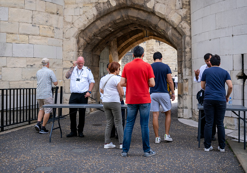 Security officials at the entrance to the Tower of London checking visitors’ bags.