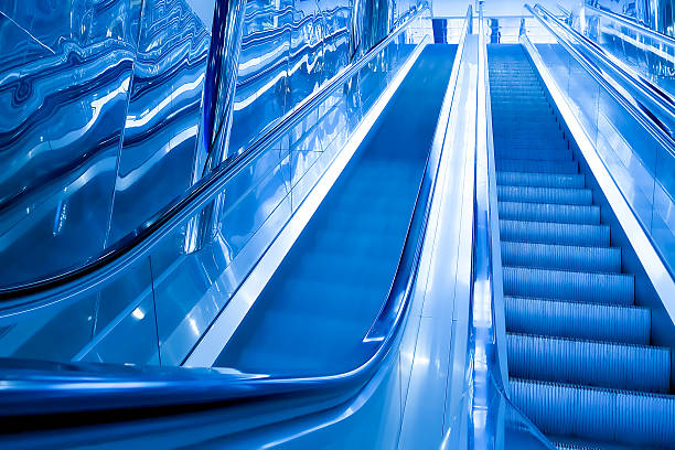istock blue modern escalator in business center 183083836