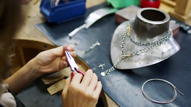 Woman designing jewelry in her atelier