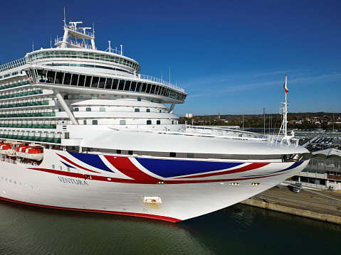 Aerial view of Ventura Cruise Ship bow with Union Jack flag at Southampton Port, UK. Sunny morning.